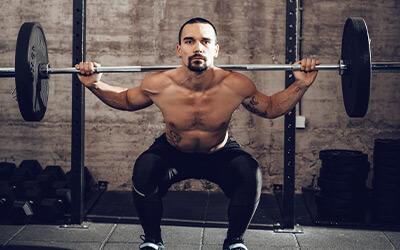 A heavily loaded barbell mid-lift