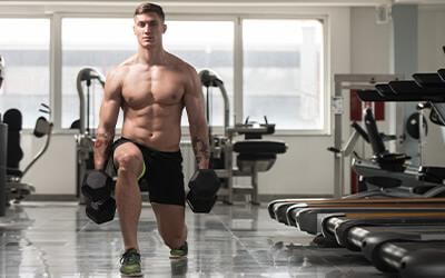 A lifter squatting under a loaded barbell