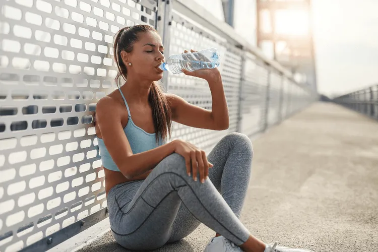 An athlete drinking water after training